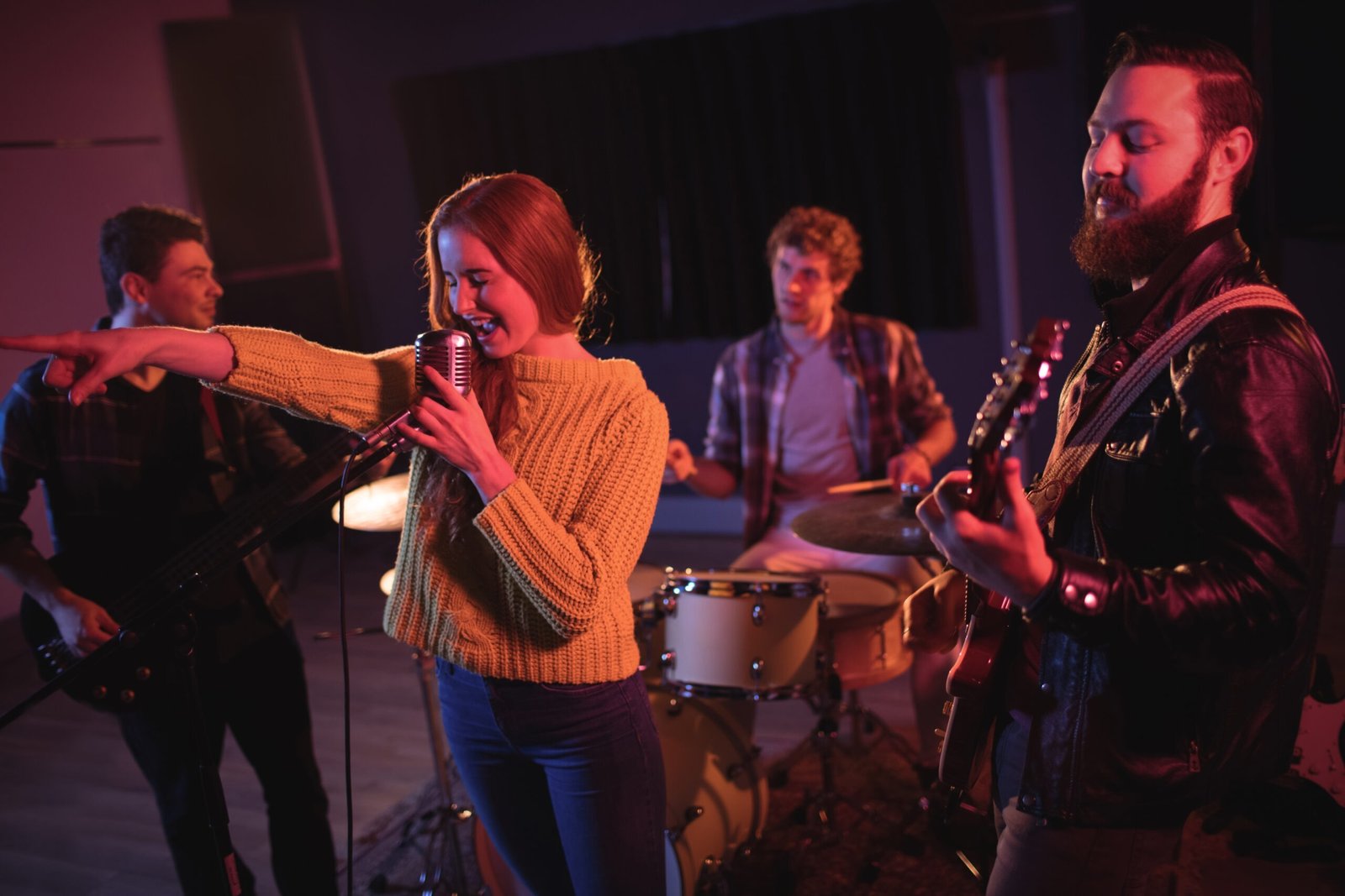Woman singing on microphone in recording studio